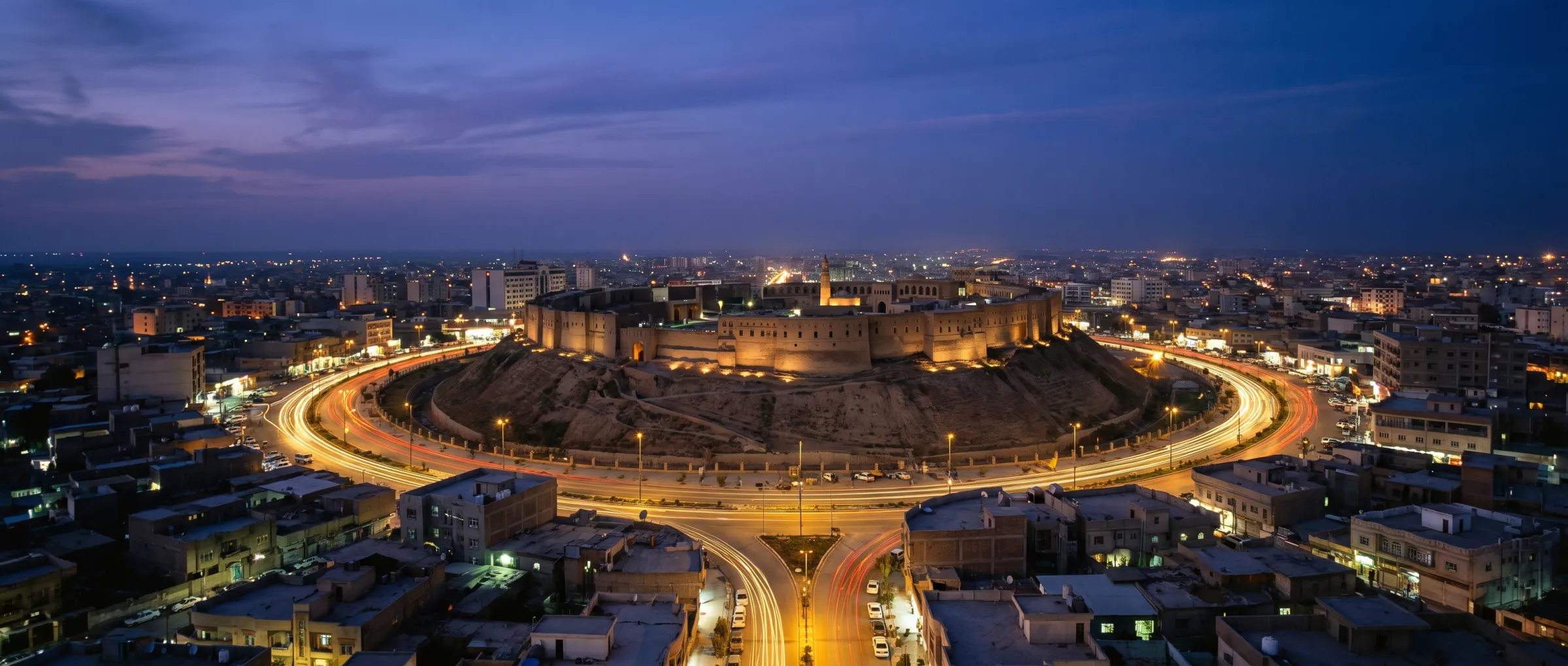 Erbil at dusk, the Citadel on its mound ringed by lit roads