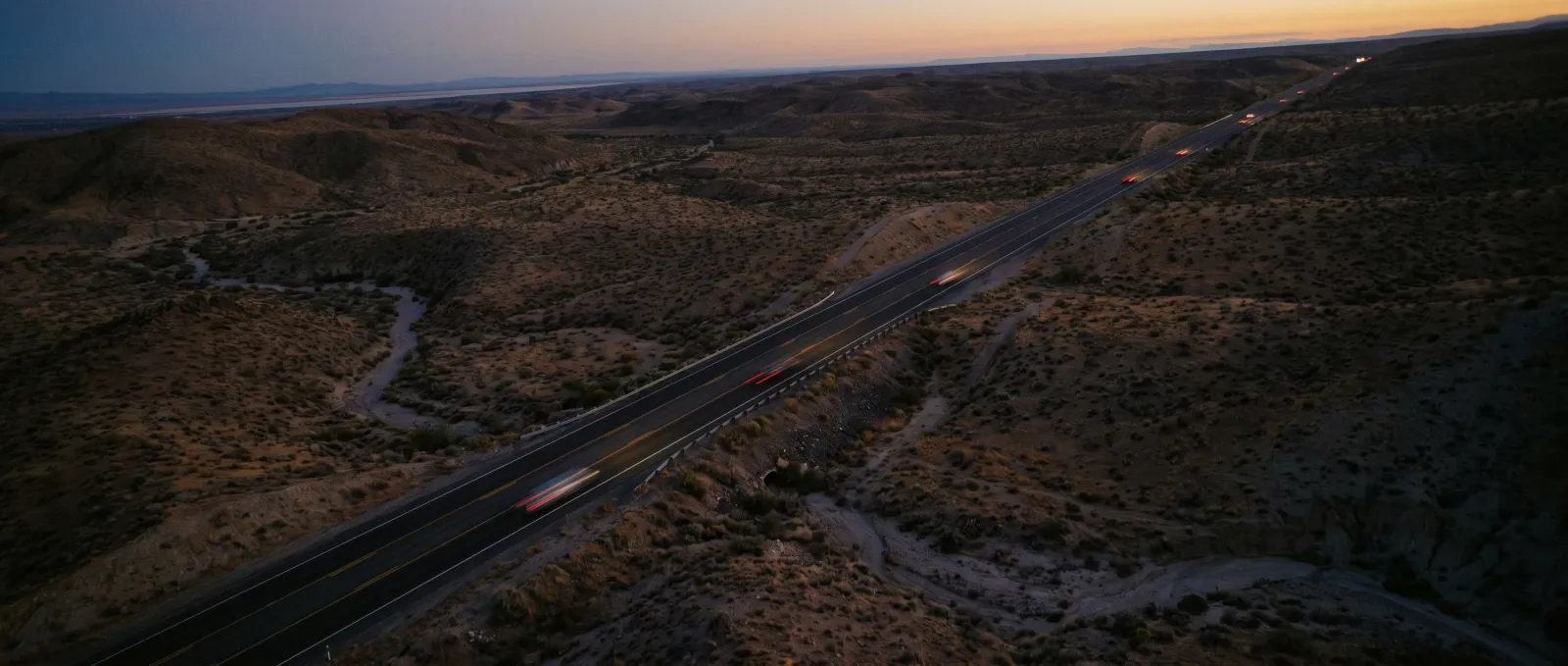 An interchange seen from directly above, traffic threading the ramps